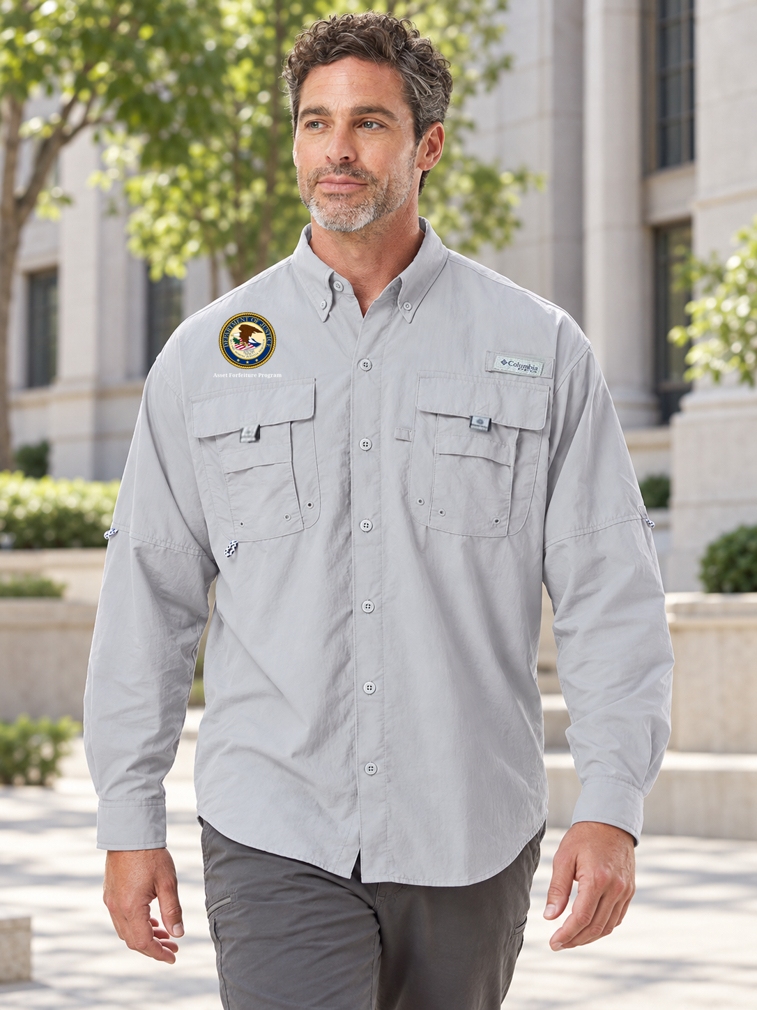 AFP men's Cool Grey Columbia Bahama II long-sleeve shirt with original source agency artwork outside a government office