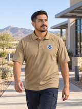 TACTICAL Dept of Homeland Security Polo- Men's Short Sleeve — Tan lifestyle view