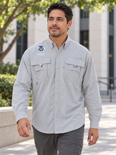 HSI men's Cool Grey Columbia Bahama II long-sleeve shirt on an administrative coordinator walking outside a federal office building.